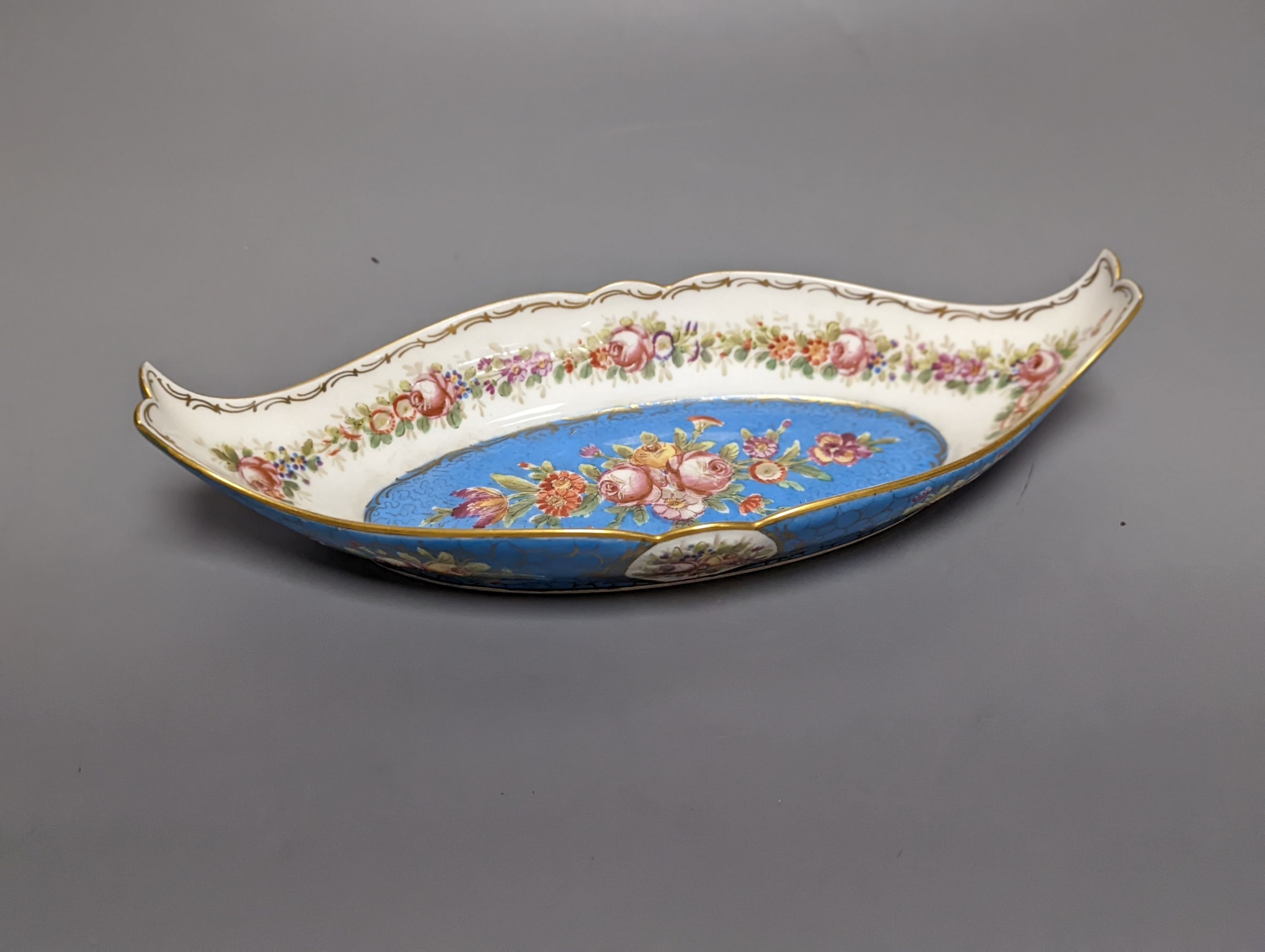 A Sevres style boat shaped dish and a Limoges circular dish, Sevres dish 27 cms wide & Limoges dish 31 cms diameter.